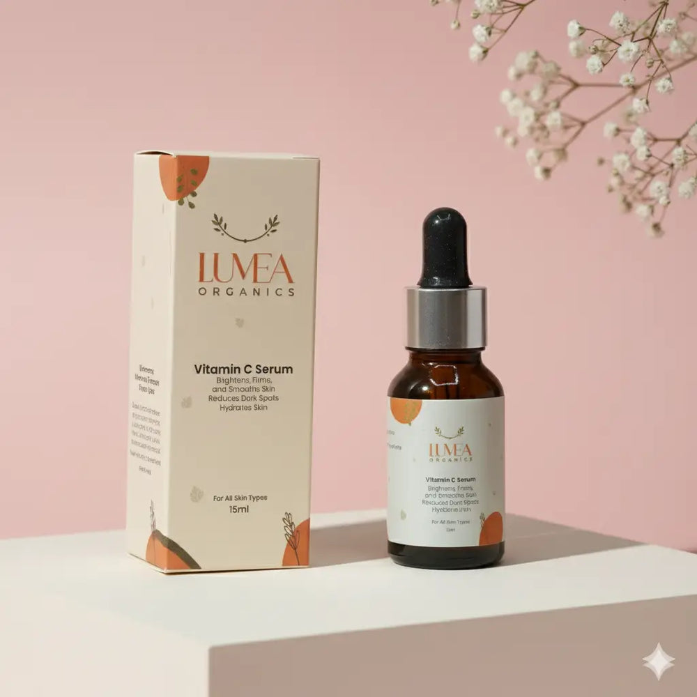 Lumea Organics Vitamin C Serum bottle and packaging on a pink background with white flowers.