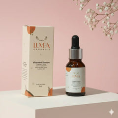 Lumea Organics Vitamin C Serum bottle and packaging on a pink background with white flowers.
